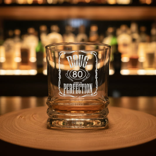 Close-up of personalised whiskey glass showing printed name and age — premium birthday gift for men