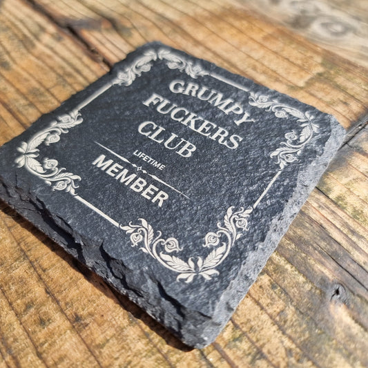 Engraved slate sign reading “Grumpy F*ckers Club Lifetime Member” with decorative vintage border, laser engraved on natural wood plaque with rustic finish.