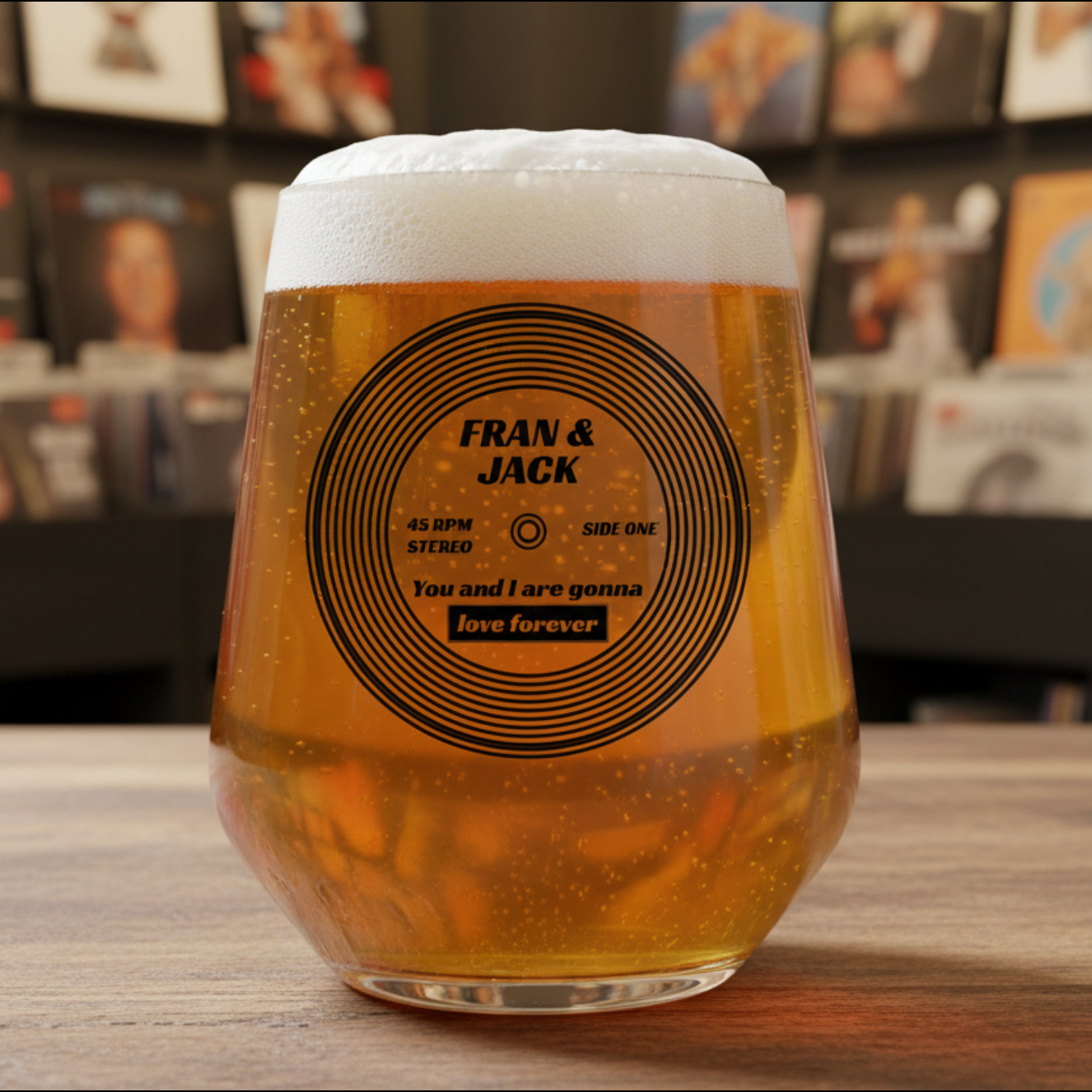 Personalised vinyl record beer glass with couple names and song title printed on the design