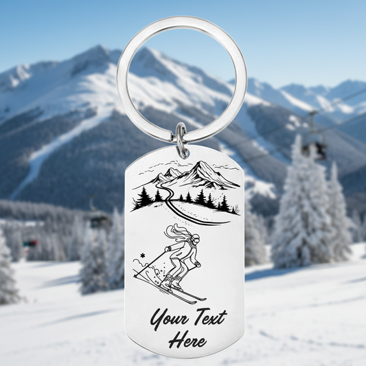 Keychain with mountain and skier design and customizable text on a white background