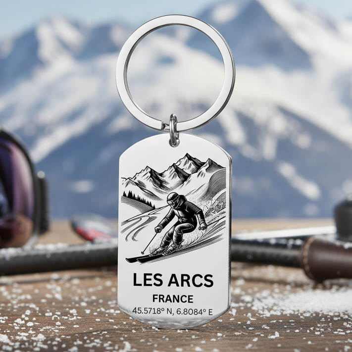 Keychain with a skier illustration and 'Les Arcs France' text on a stainless steel dog tag