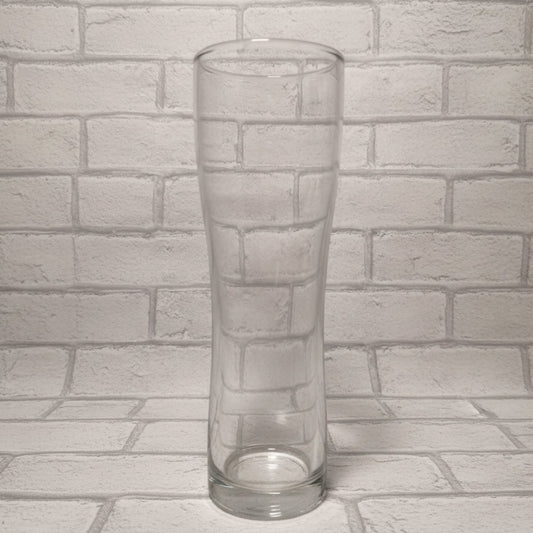 Plain 1-pint Aspen schooner beer glass on wooden surface shown before custom design is applied — wide-bodied shape with handle-free design