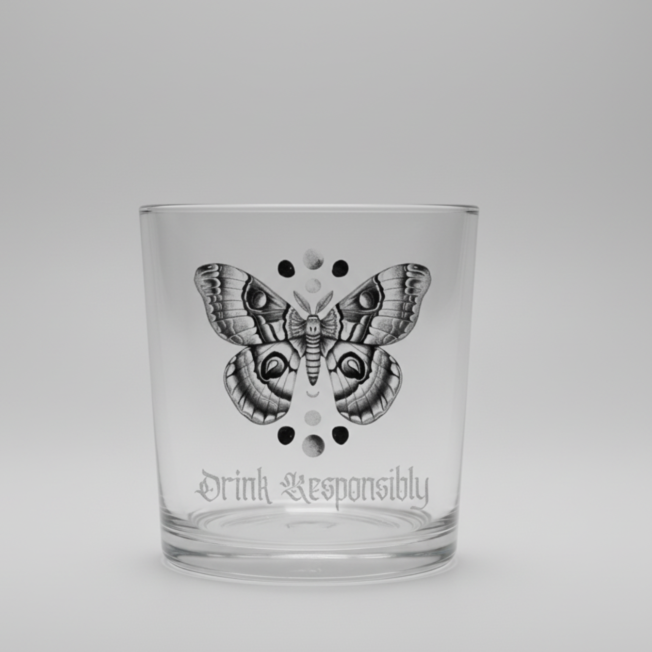 Gothic moth whiskey glass showing full design detail — moth illustration, moon phase dots and personalised base text