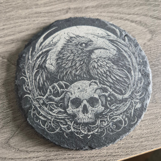 Close up of intricate laser engraved raven and skull gothic design on premium natural slate coaster showing extraordinary detail