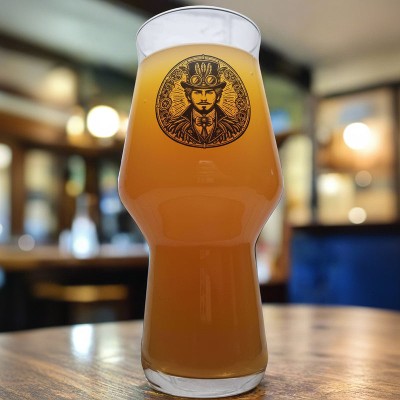 A steampunk-themed beer glass with a graphic of a man surrounded by gears, placed on a wooden surface.