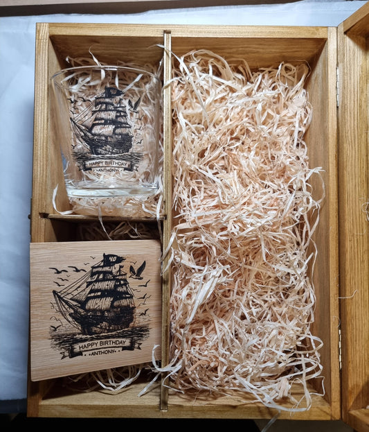 Close-up of ship design on personalised rum glass showing detailed tall-masted sailing ship print with custom name