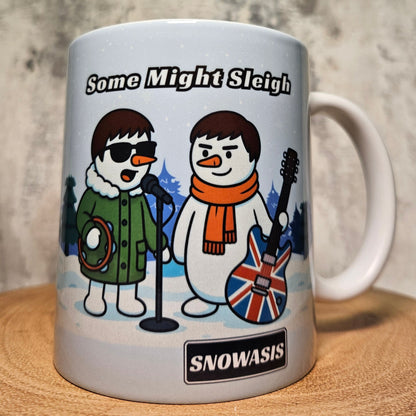 White ceramic mug with cartoon snowmen holding musical instruments and the text “Some Might Sleigh”.