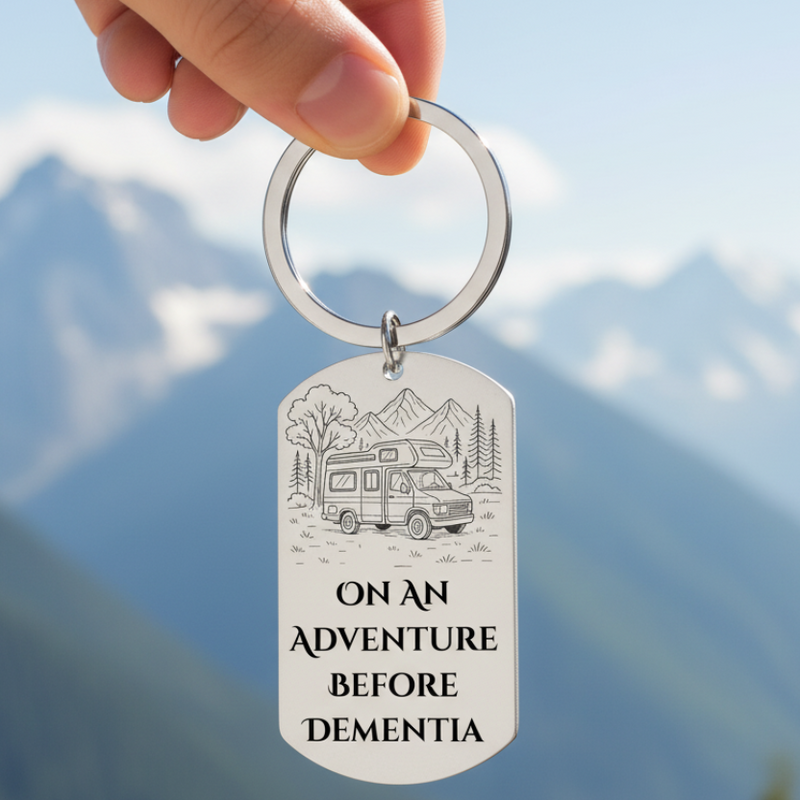 Stainless steel keyring with campervan engraving and text saying “On an Adventure Before Dementia”