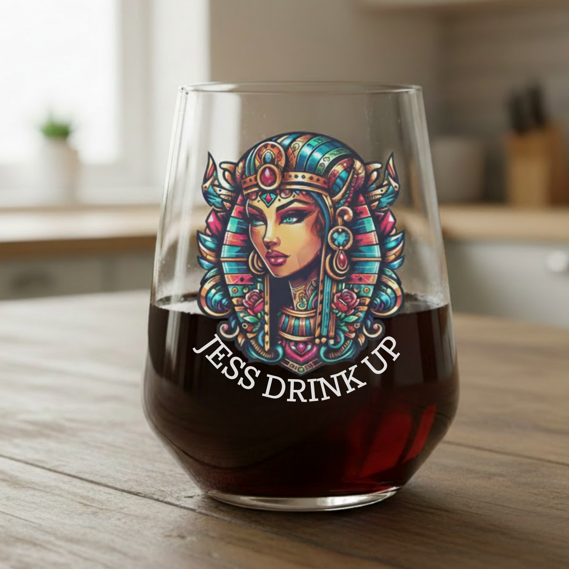 Stemless wine glass with a colorful Egyptian cleopatra printed and custom text design and 'Jess Drink Up' 