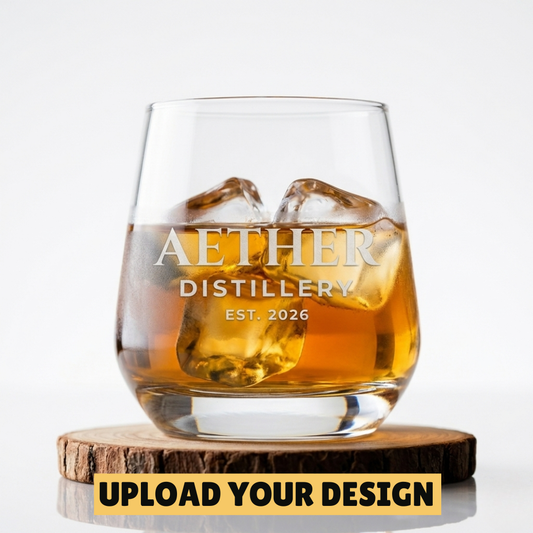 Personalised 345ml stemless whiskey tumbler with custom uploaded Aether Distillery design filled with whiskey and ice