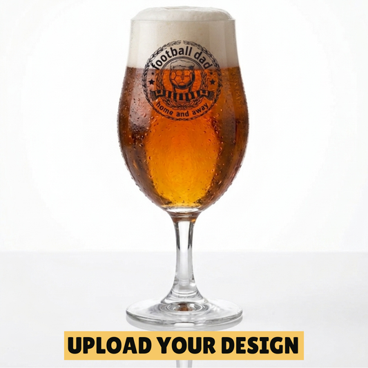 Personalised 568ml chalice pint glass with custom uploaded football dad home and away badge design filled with golden beer on marble surface