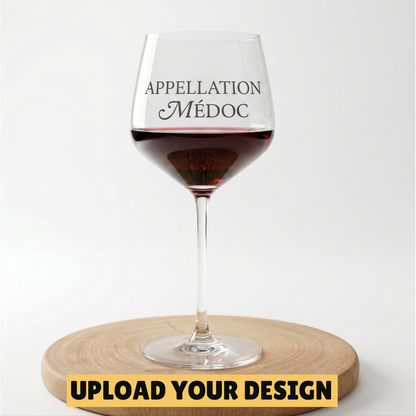 Personalised 650ml large stemmed wine glass with custom uploaded Appellation Medoc design filled with red wine on wooden board