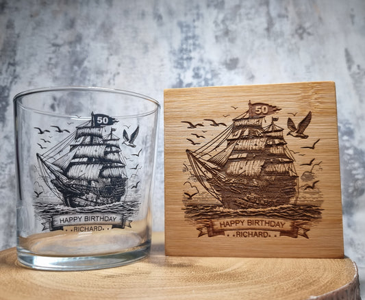Personalised rum glass with ship design, custom name and age, shown with optional bamboo coaster and varnished wooden gift box – nautical themed gift for him