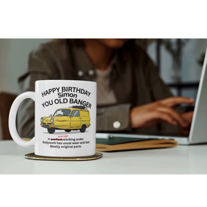 Personalised You Old Banger funny birthday mug on a desk 
in an office lifestyle setting