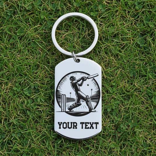 Personalised laser engraved stainless steel cricket keyring with 
cricket batsman design and custom text on grass background