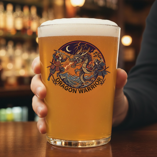 Personalised samurai dragon pint glass filled with beer on a bar counter, featuring two armoured samurai warriors battling a fire-breathing dragon under a crescent moon with custom text engraving