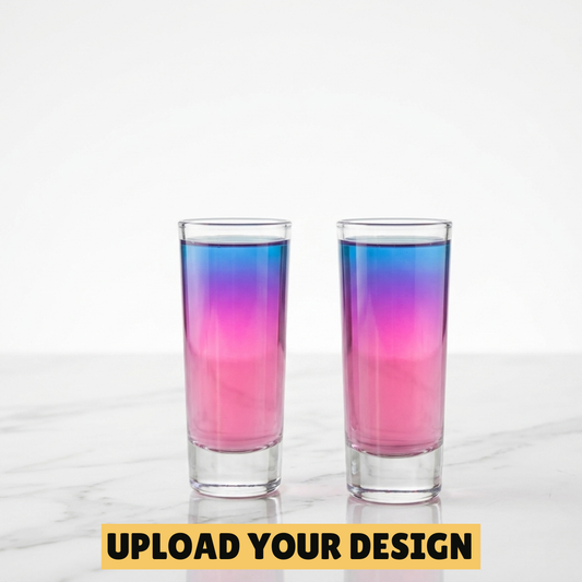 Personalised set of two 60ml tall shot glasses filled with pink and blue layered cocktail on marble surface, unique party gift