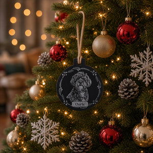 Personalised slate Christmas bauble laser engraved with an uploaded dog photo in a wreath design and the name Charlie