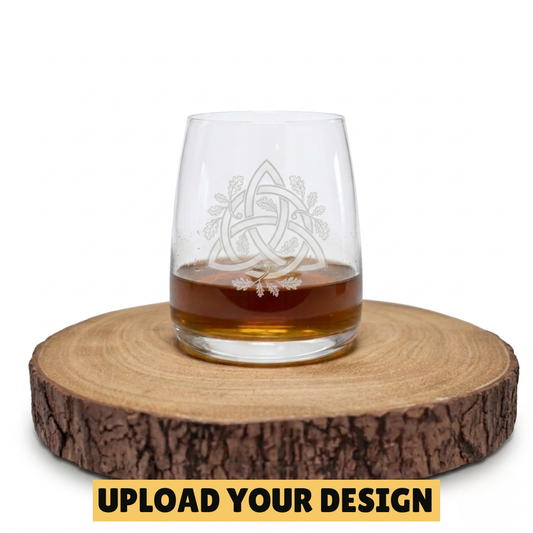 Personalised stemless whiskey glass with custom uploaded Celtic trinity knot oak leaf design on wooden board, unique gift for him