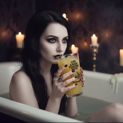 Clear drinking glass with “Live Laugh Toaster Bath” text and skeleton in bathtub with toaster – funny dark humour glass for goth, emo, or alternative gifts