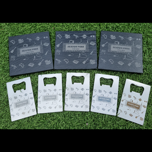 Set of branded britpop heaton park concert bottle openers on grass