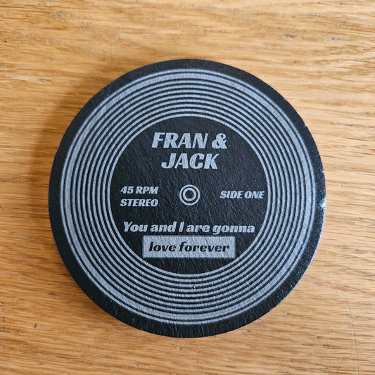 Set of two personalised laser engraved vinyl record coasters styled as 45 RPM singles, custom Britpop couples gift engraved with song names and couple names