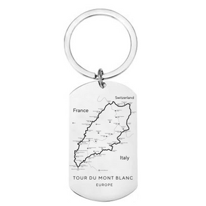 Tour du Mont Blanc route map laser engraved stainless steel dog tag keyring showing complete TMB circular trail through France Italy and Switzerland with refuges and cols on white background
