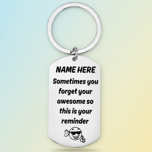 Personalised 'you're awesome' keyring with custom name placeholder, displaying the message 'Sometimes you forget your awesome so this is your reminder' with a smiling character wearing sunglasses