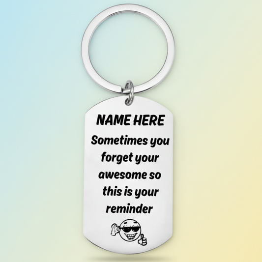 Personalised 'you're awesome' keyring with custom name placeholder, displaying the message 'Sometimes you forget your awesome so this is your reminder' with a smiling character wearing sunglasses