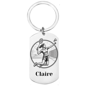 Personalised badminton keyring laser engraved stainless steel dog tag with female player jump smash circular medallion design and personalised name on white background