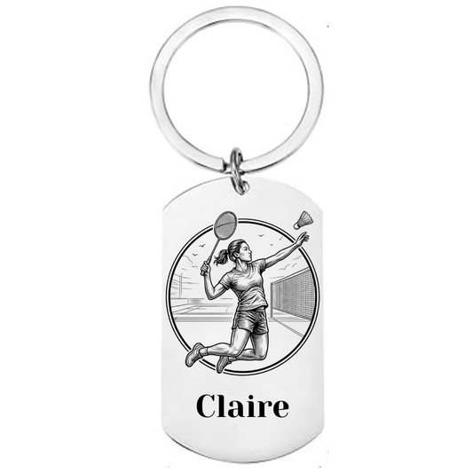Personalised badminton keyring laser engraved stainless steel dog tag with female player jump smash circular medallion design and personalised name on white background