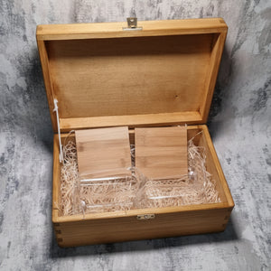 Wooden glassware box with bamboo coasters case on a textured gray surface