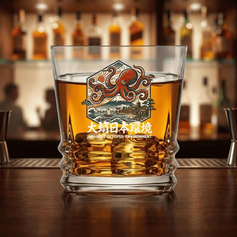 custom Japanese Octopus Environment whiskey rocks glass filled with bourbon on a bar counter, featuring ukiyo-e art design with red octopus, Mount Fuji, waves and Japanese kanji engraving