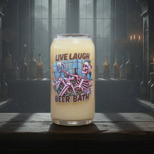 Can style glass 'Live Laugh Beer Bath' with a skeleton design on a wooden surface.