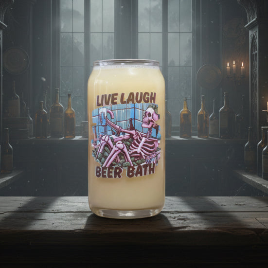 Can style glass 'Live Laugh Beer Bath' with a skeleton design on a wooden surface.