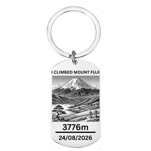 I Climbed Mount Fuji laser engraved stainless steel dog tag keyring with Japanese landscape illustration cherry blossom pine tree stone lanterns and personalised climb date on white background