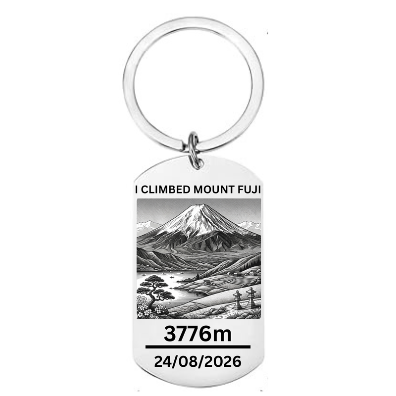 I Climbed Mount Fuji laser engraved stainless steel dog tag keyring with Japanese landscape illustration cherry blossom pine tree stone lanterns and personalised climb date on white background