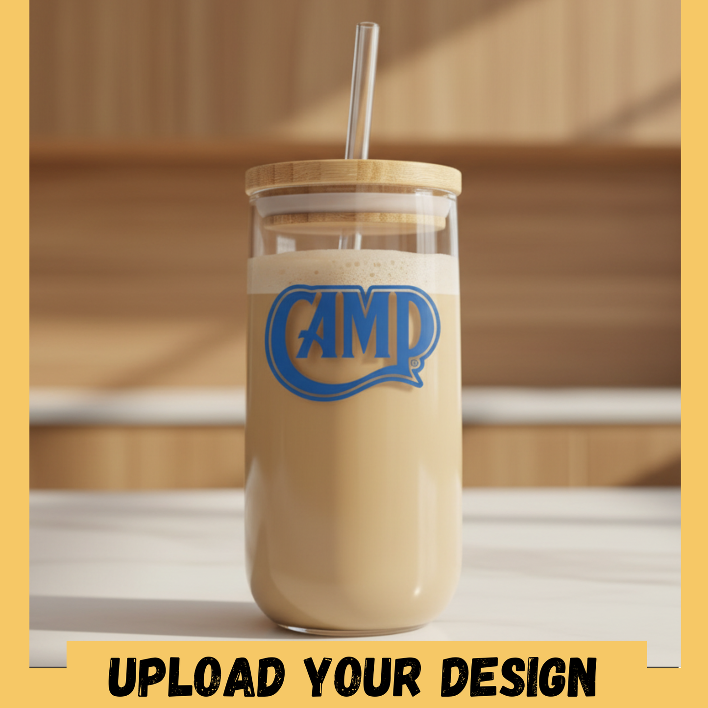 Glass tumbler with a wooden lid and straw, containing a creamy beverage with 'CAMP' logo, on a wooden surface.