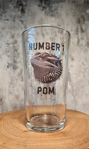 Personalised animal pint glass featuring a bearded dragon illustration with custom text above and below, fully customisable beer glass gift with choice of animal and any personalised wording, shown filled with golden beer on neutral background