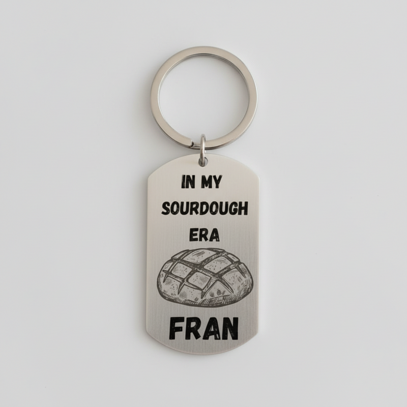 Personalised stainless steel keyring laser engraved with In My Sourdough Era text, name, and bread illustration