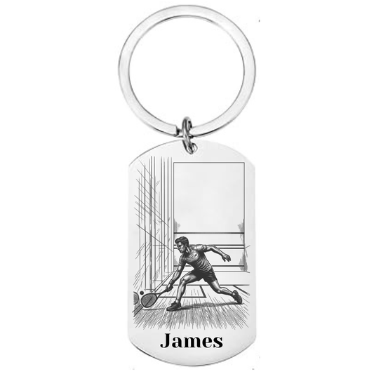 Personalised squash keyring laser engraved stainless steel dog tag with male squash player court scene and personalised name on white background