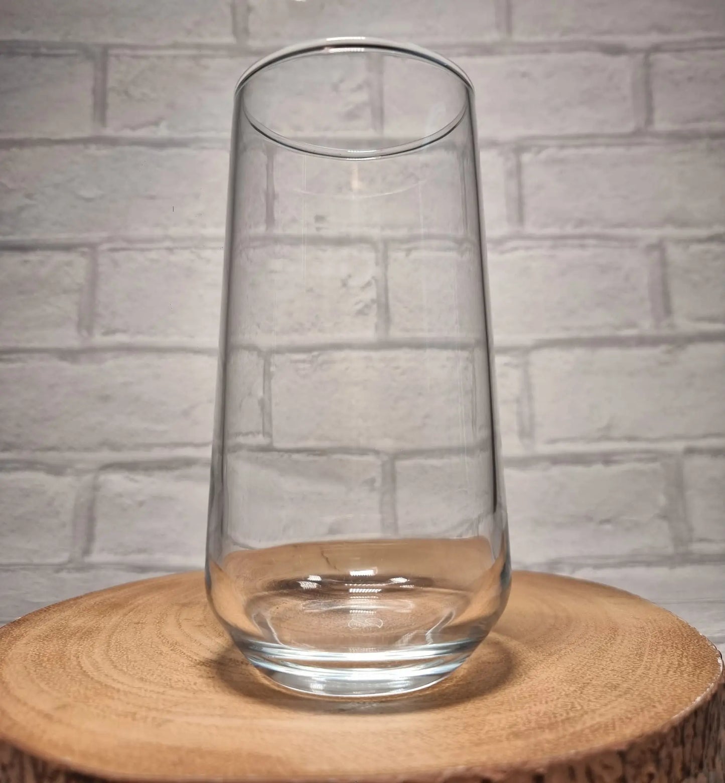 Close up of custom printed circular design on personalised stemless glass showing name and hobby artwork