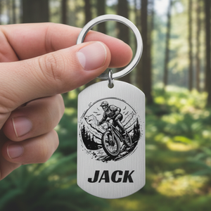 Keychain with a cyclist design and custom text on a white background